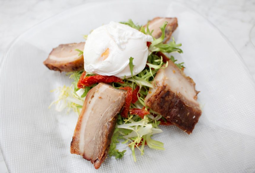 frisee salad with warm braised pork belly sun-dried tomatoes and